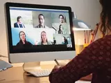 Person spricht per Videokonferenz am Computer mit anderen Personen